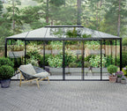Hexagonal glass gazebo with a chair on a paved patio surrounded by greenery